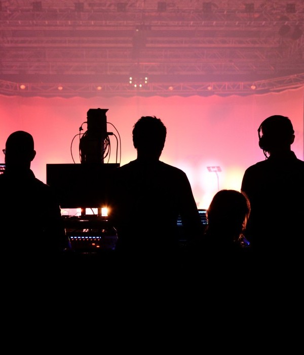 An image of a production team working behind the controls panel at an event.