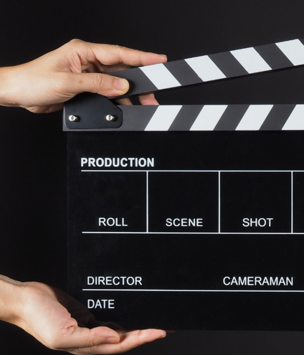 An image of a someone holding a clapper board open.